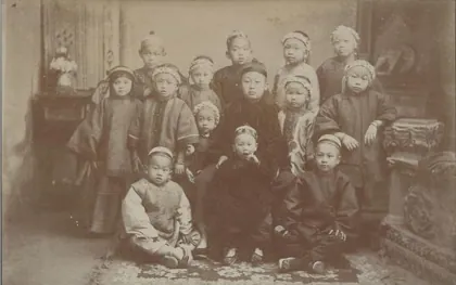 Fourteen children in traditional Chinese dress, 1886