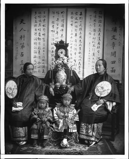 Chinese mother, daughter and children in fine costume, 1900